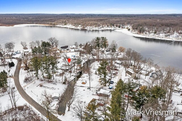 snowy aerial view featuring a water view