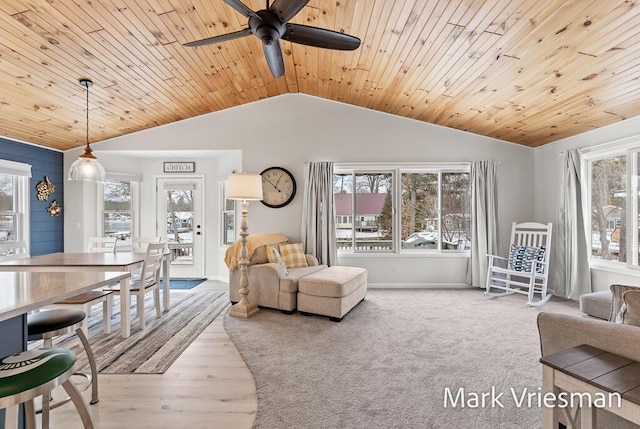 carpeted living room with vaulted ceiling, plenty of natural light, and wooden ceiling