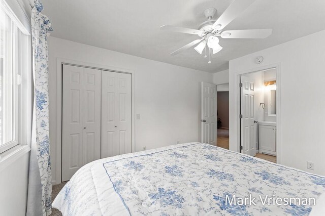 bedroom with ceiling fan, ensuite bathroom, and a closet