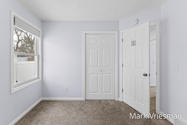 unfurnished bedroom with carpet floors