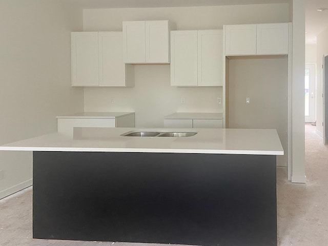 1979 N Shorewood Ln Unit 7, Holland, MI 49423 - kitchen featuring a kitchen island with sink, white cabinets, concrete floors, and baseboards