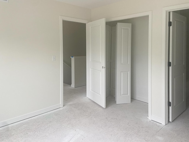 1979 N Shorewood Ln Unit 7, Holland, MI 49423 - unfurnished bedroom featuring baseboards and light colored carpet