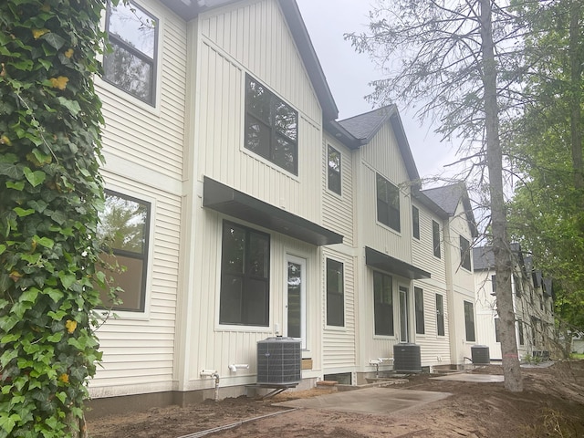1979 N Shorewood Ln Unit 7, Holland, MI 49423 - rear view of house with central AC and a shingled roof