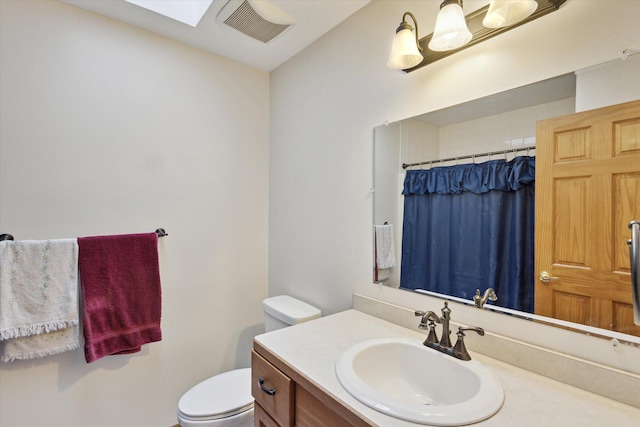 bathroom featuring vanity, a shower with shower curtain, and toilet