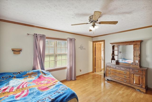 bedroom with a textured ceiling, light hardwood / wood-style flooring, ceiling fan, and ornamental molding