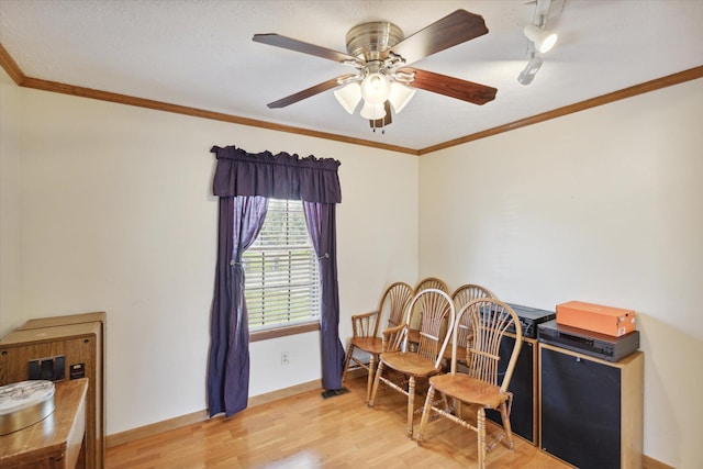 interior space with ceiling fan, light hardwood / wood-style floors, and ornamental molding