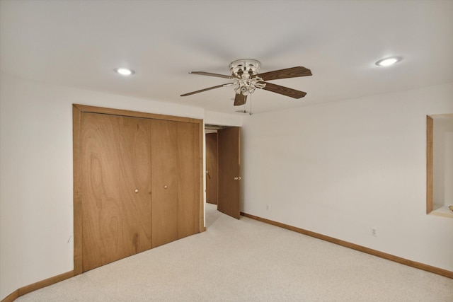 unfurnished bedroom with ceiling fan, a closet, and light carpet