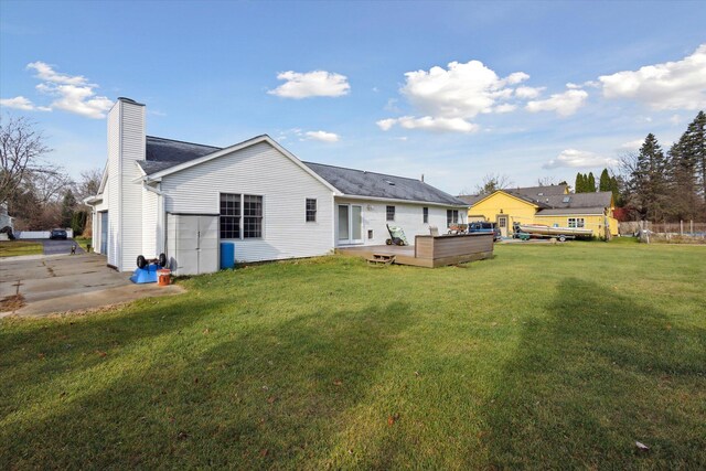 back of house with a wooden deck and a yard