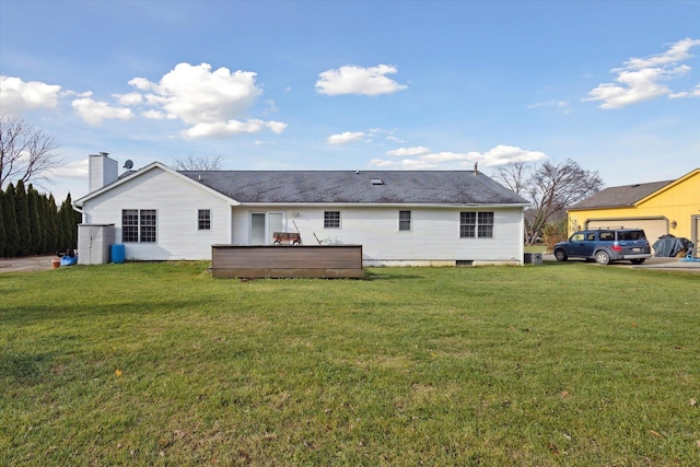 rear view of house featuring a lawn