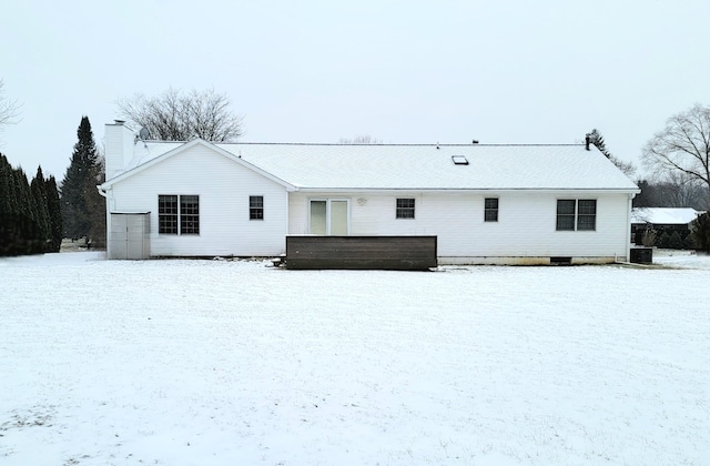 snow covered property featuring central AC unit