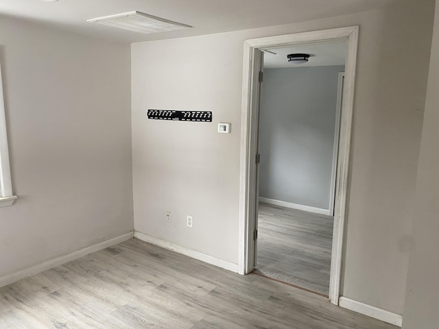 spare room with light hardwood / wood-style flooring