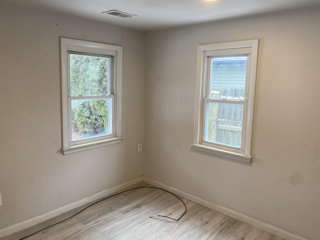 unfurnished room with hardwood / wood-style flooring