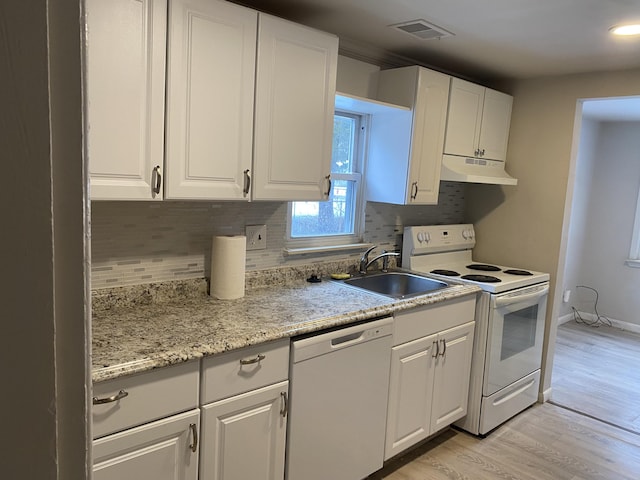 kitchen with decorative backsplash, white appliances, sink, white cabinets, and light hardwood / wood-style floors