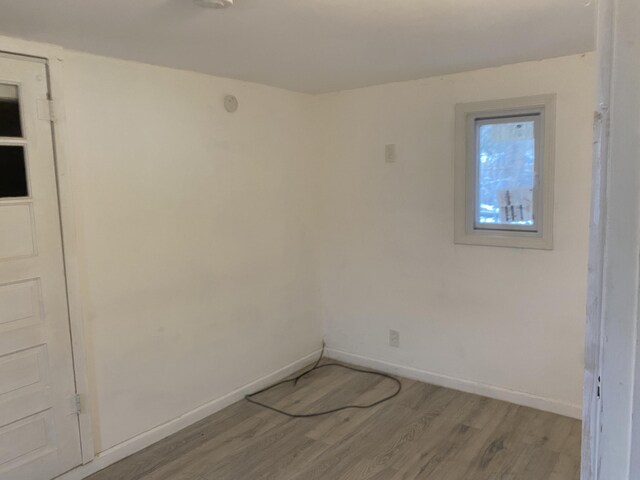 empty room with light hardwood / wood-style flooring