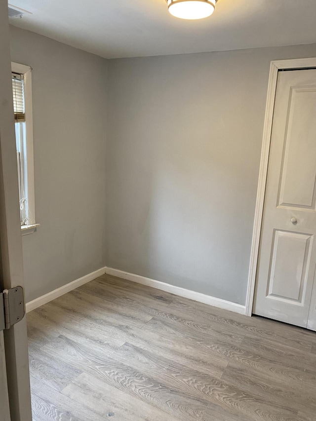 empty room with light hardwood / wood-style floors