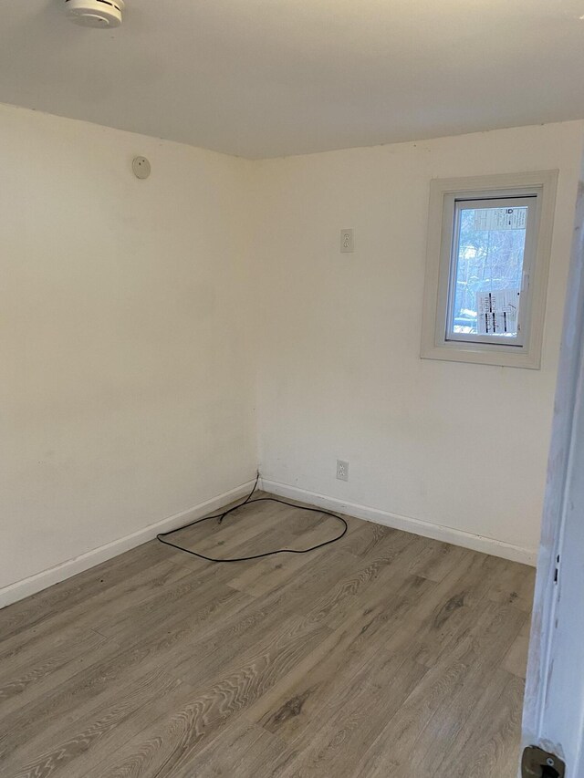 unfurnished room with hardwood / wood-style flooring