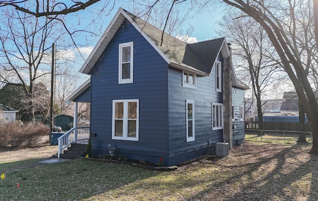 view of home's exterior with a lawn and cooling unit