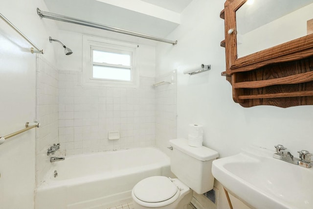 full bathroom with tile patterned floors, toilet, tiled shower / bath, and sink