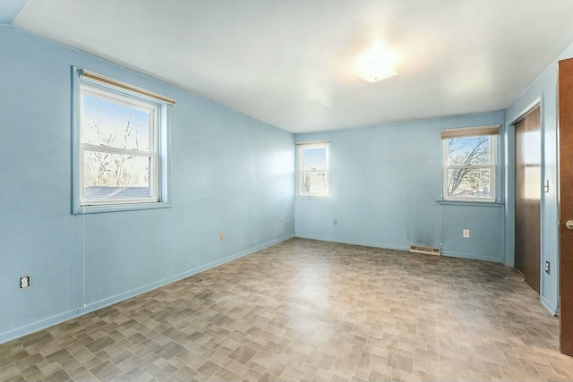 spare room featuring a wealth of natural light