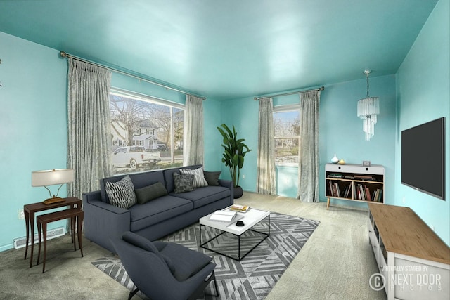 living room featuring carpet and a chandelier