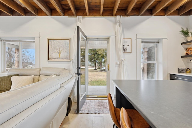 kitchen with beamed ceiling, light wood-type flooring, plenty of natural light, and wooden ceiling