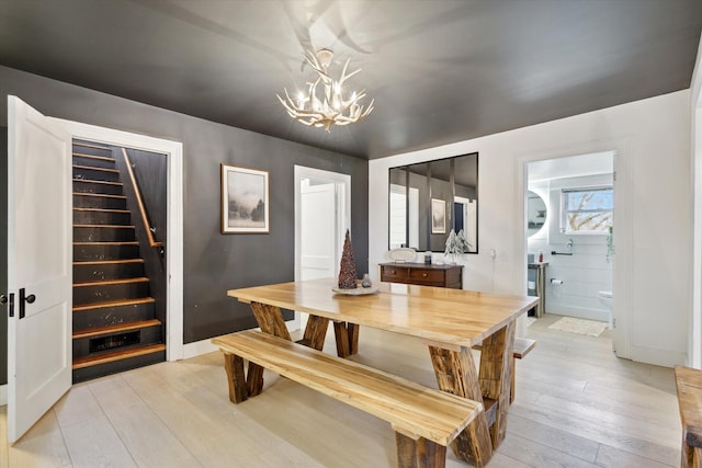 dining area featuring light hardwood / wood-style floors and a chandelier