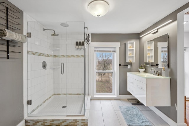 bathroom with tile patterned floors, vanity, and walk in shower