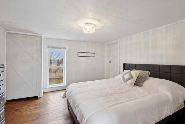 bedroom with dark hardwood / wood-style floors