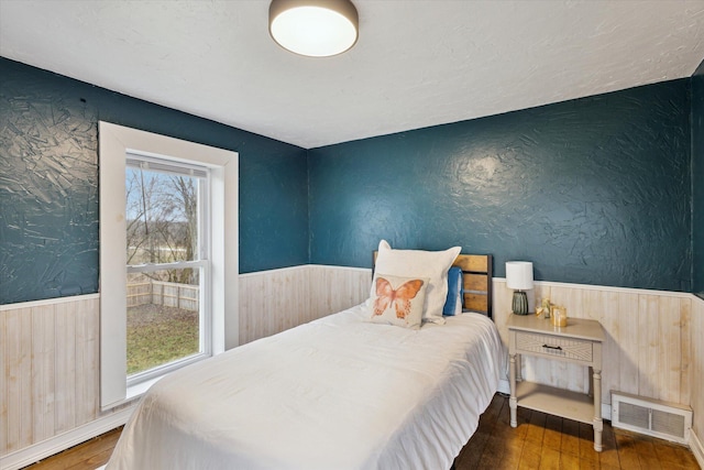 bedroom with dark wood-type flooring