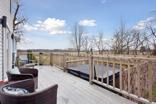 deck featuring a covered hot tub