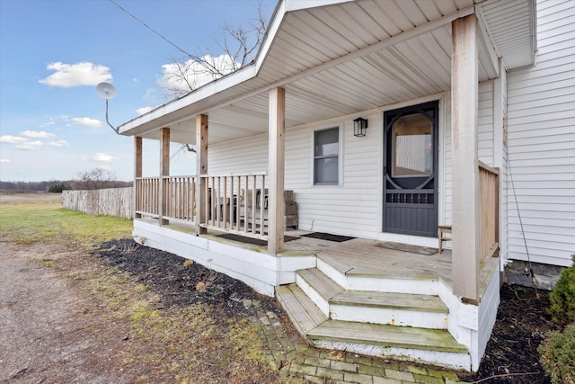 view of exterior entry featuring a porch