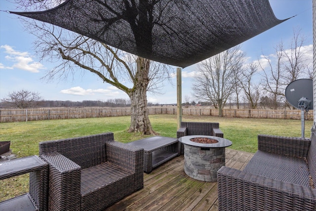 deck featuring a fire pit, a rural view, and a lawn