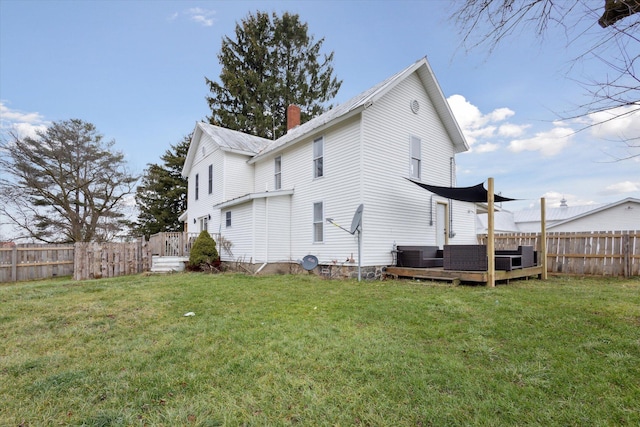 rear view of property featuring a lawn, a wooden deck, and central AC unit