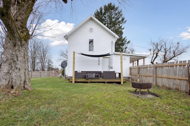 rear view of property featuring a deck and a lawn