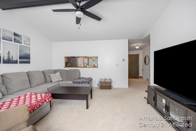 living room featuring ceiling fan, light carpet, and vaulted ceiling