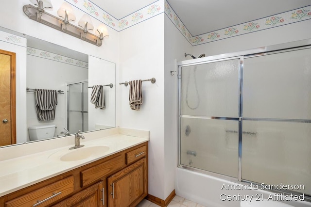 full bathroom with vanity, enclosed tub / shower combo, and toilet