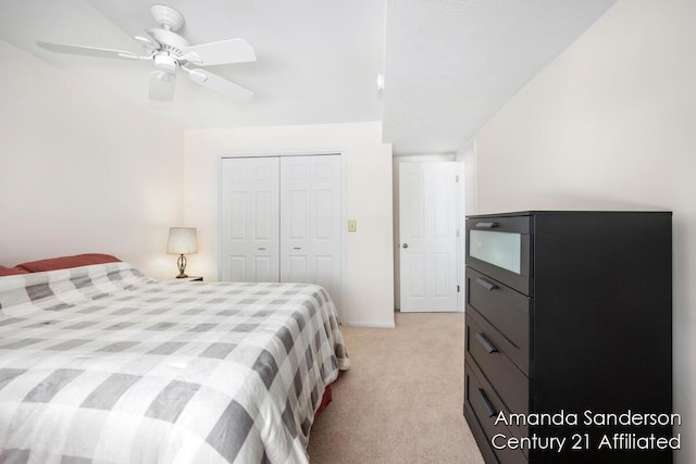 bedroom featuring light carpet, a closet, and ceiling fan