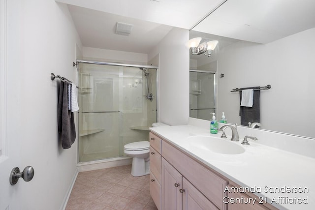 bathroom with vanity, toilet, and an enclosed shower