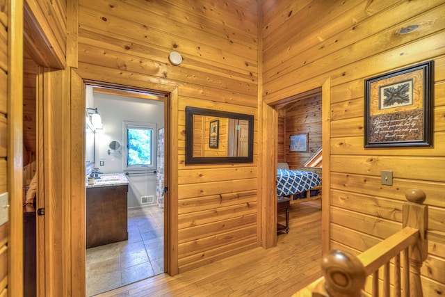 hallway with wood walls