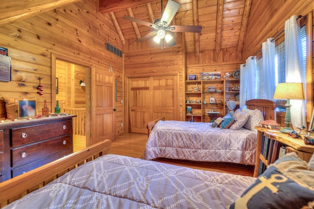 bedroom featuring ceiling fan, high vaulted ceiling, wooden ceiling, beamed ceiling, and wood walls