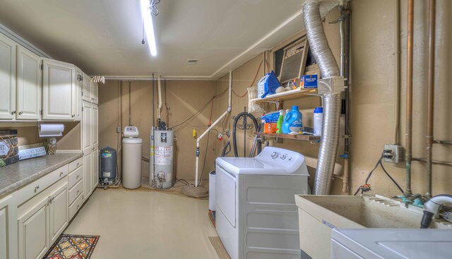 laundry area featuring washer and dryer, cabinets, sink, and gas water heater