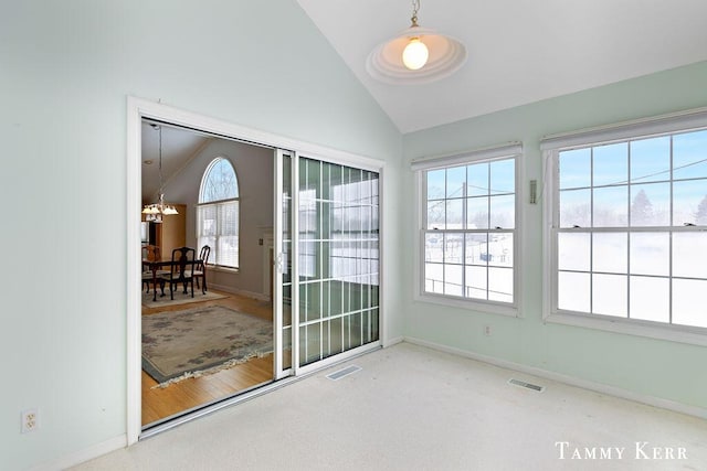 unfurnished sunroom featuring a chandelier and lofted ceiling