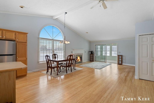 dining room featuring vaulted ceiling with beams, ceiling fan, and light wood-type flooring