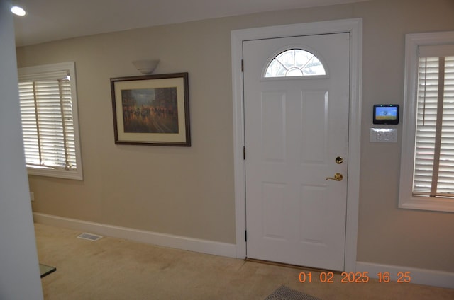 view of carpeted entrance foyer