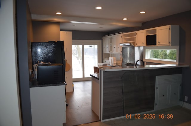 kitchen featuring light hardwood / wood-style floors, a wealth of natural light, white cabinetry, and kitchen peninsula