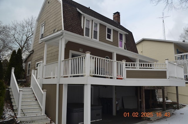 back of house with a hot tub