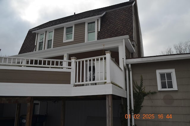 view of side of property featuring a balcony