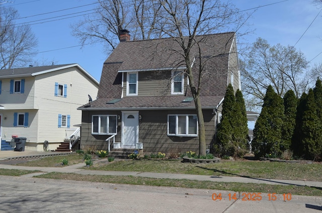 dutch colonial with a chimney, a gambrel roof, roof with shingles, and entry steps