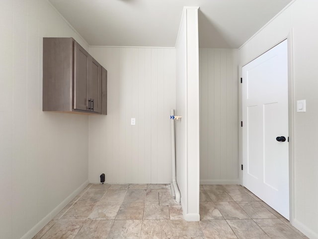 laundry room featuring cabinets and wood walls