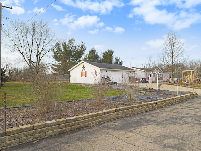 manufactured / mobile home featuring a garage and a front lawn